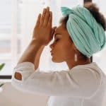 Woman practicing meditation indoors with a focus on relaxation and mindfulness.