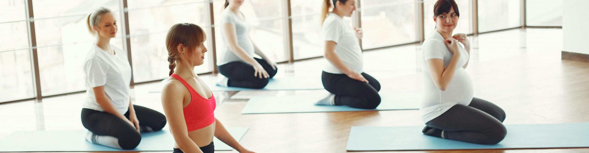 Group of women practicing yoga in a bright, spacious studio in Tenerife.